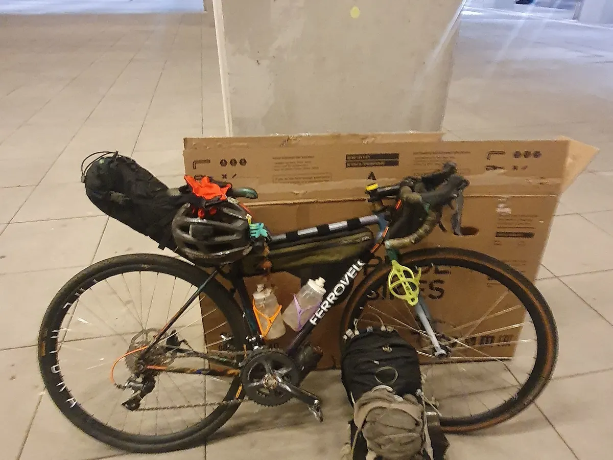 柏林機場航廈內，一台裝滿馱包的旅行車靠在攤平的單車紙箱前